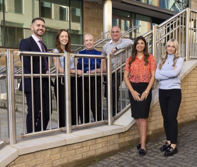 Group of Muckle trainees and employees in front of Muckle offices in Newcastle