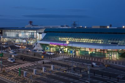 Aerial shot of Newcastle International Airport entrance at night or dusk.