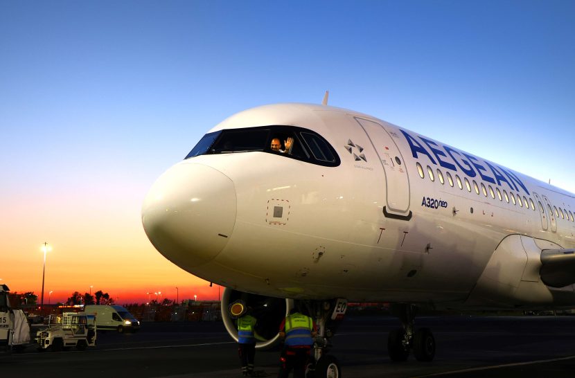 Image of Aegean plane at the airport with pilot waving out of the window.