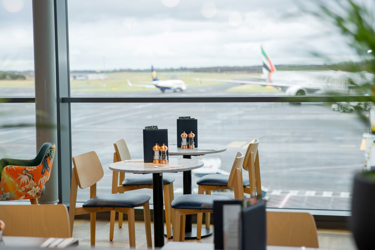 Image of dining tables looking out onto the airfield