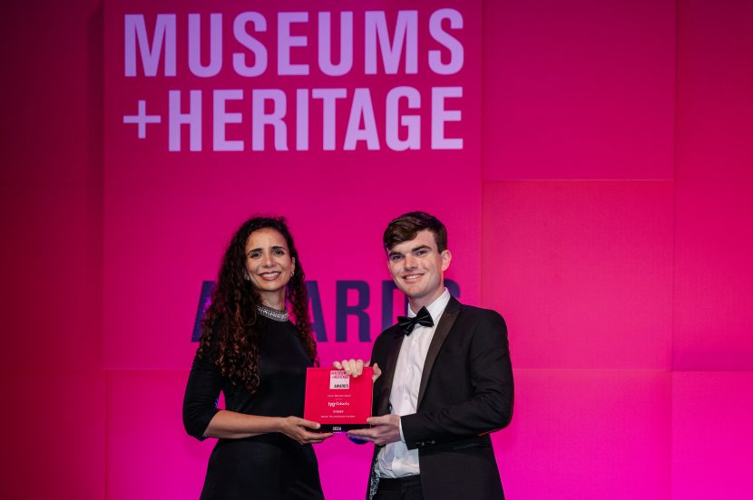 Beamish Museum representative accepting Museums Heritage Award on stage.