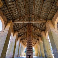 Interior of the Dutch Barn looking up from the floor to the ceiling. The ceiling has intricate wooden pattern on it.