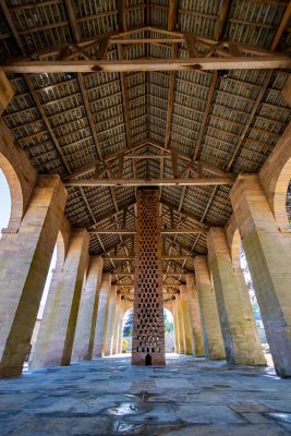 Interior of the Dutch Barn looking up from the floor to the ceiling. The ceiling has intricate wooden pattern on it.