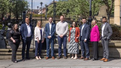 Some of Ward Hadaway team stood outside in the sun smiling to camera.