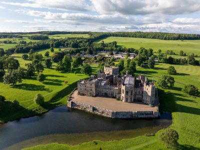 Aerial image of Raby Castle surrounded by green fields and trees.