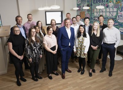 Ian Kelsall with some of UNW’s Audit & Assurance Team in their office smiling to camera