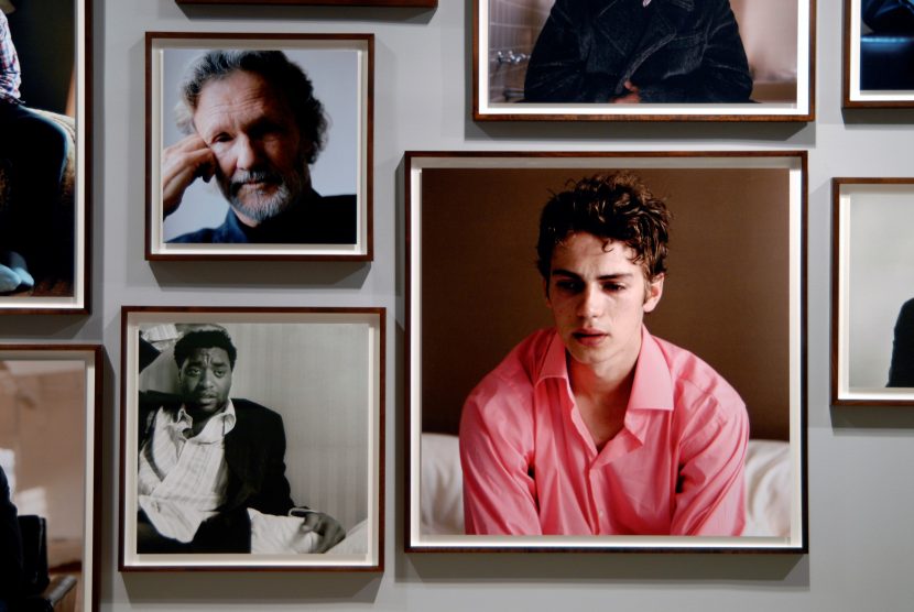 Various headshots on a wall