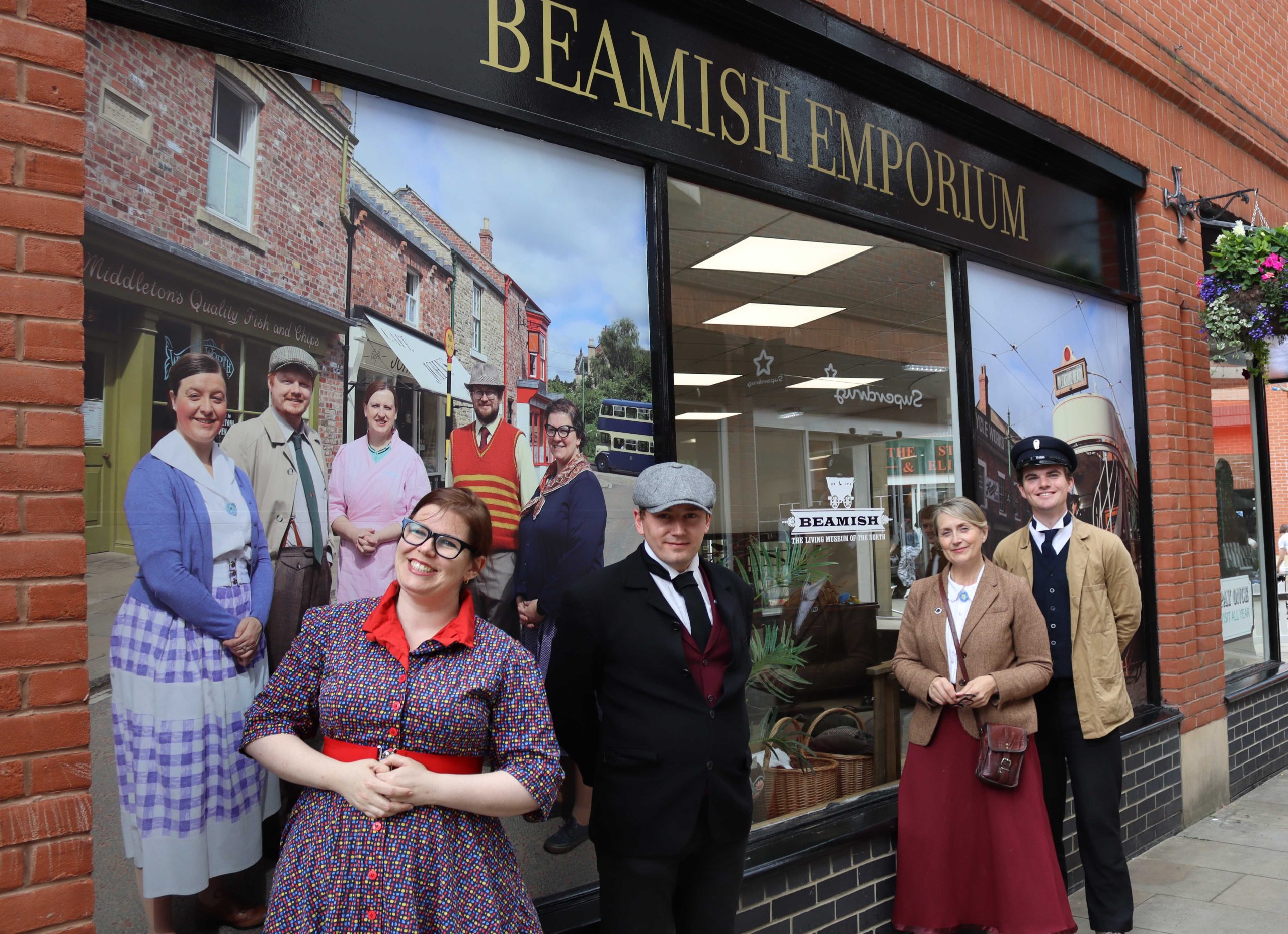 Beamish Museum staff in 1900s costume in front of 'Beamish Emporium' store front.