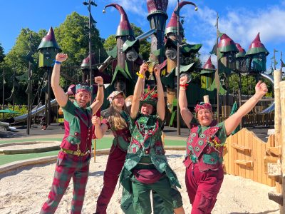 Group of four people in elf-like costumes outside of the Lilidorei play park.
