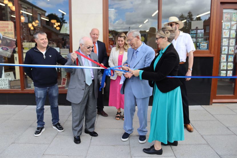 Group of people cutting ribbons outside of new Beamish Museum exhibit.