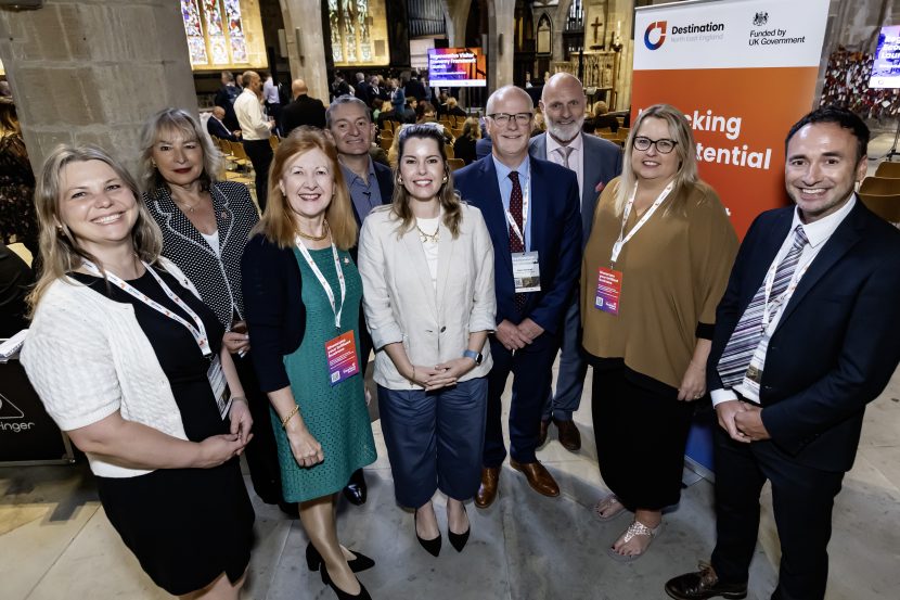 Group of regional leaders smiling to camera stood inside Newcastle Cathedral.