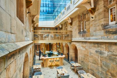 Interior bar and restaurant with light stone walls.