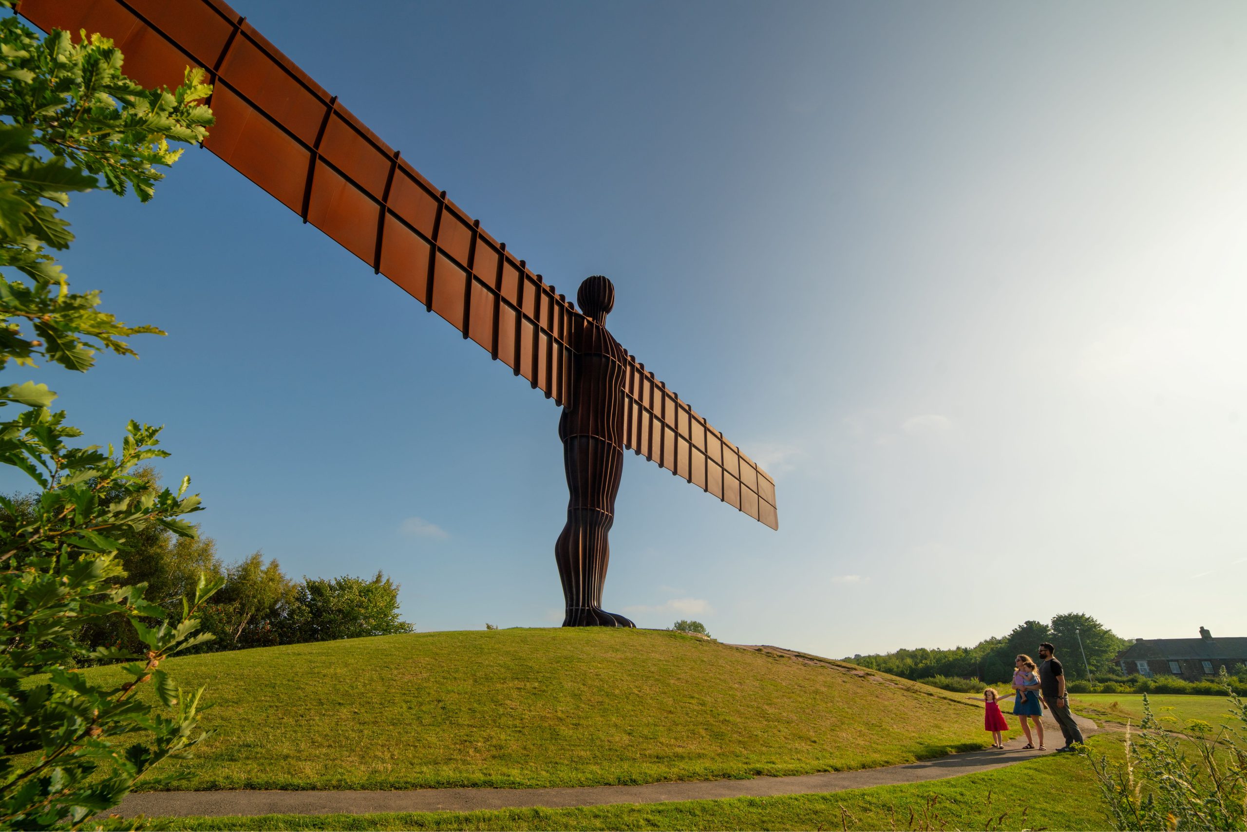 Image of Angel of the North statue on a grassy hill.